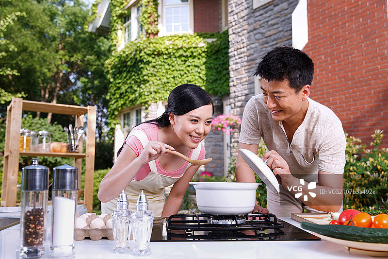 年轻夫妇在厨房做饭图片素材