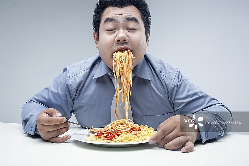 肥胖的商务男吃东西图片素材