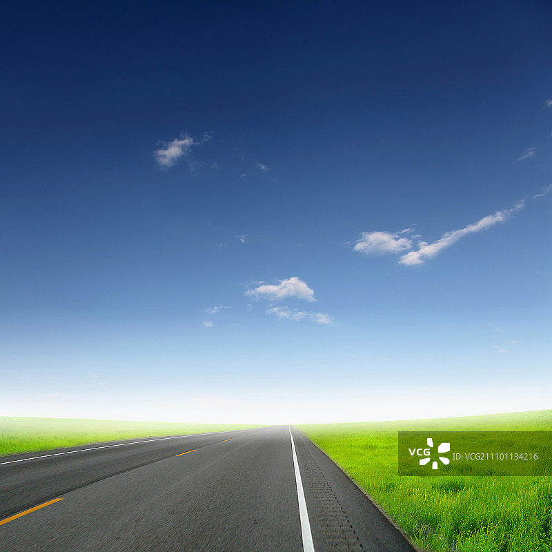 通往地平线的空旷道路和多云天空的照片图片素材