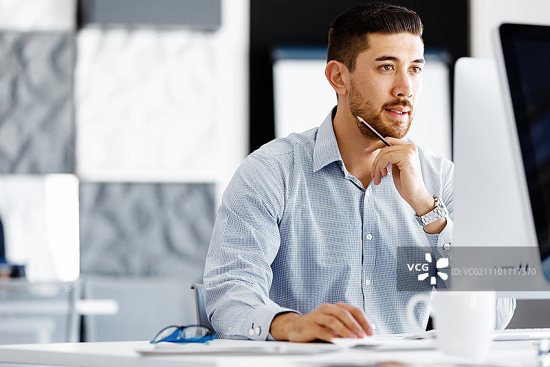 坐在办公桌旁的男职员图片素材