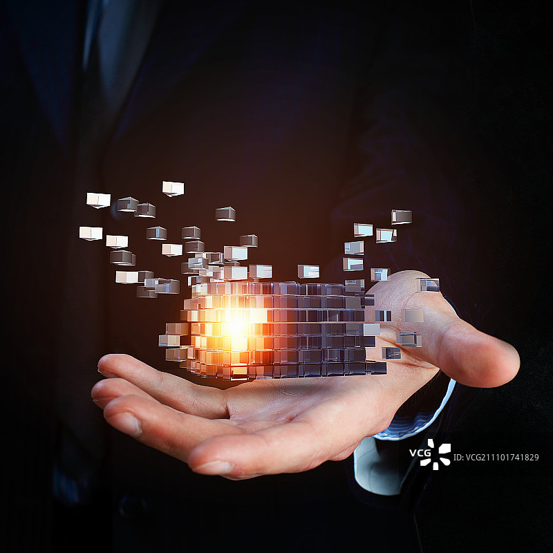人力资源概念：商人手持发光魔方特写图片素材