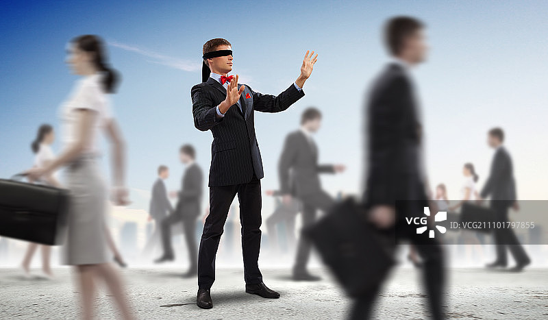 蒙眼商人在人群中行走图片素材