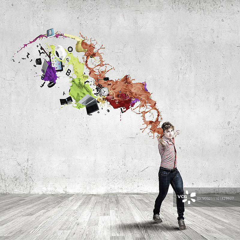 魔术师：年轻人随意泼洒彩色油漆图片素材