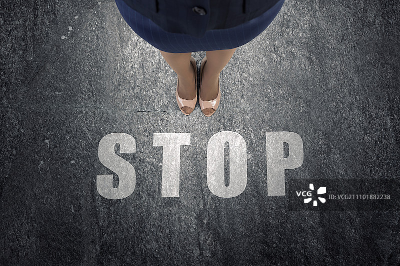 停在这里。商务女性的脚和停止标志俯视图图片素材