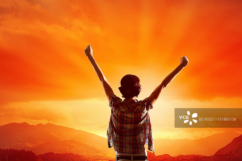 面朝新的一天：快乐的女子双手举起，面朝日出图片素材