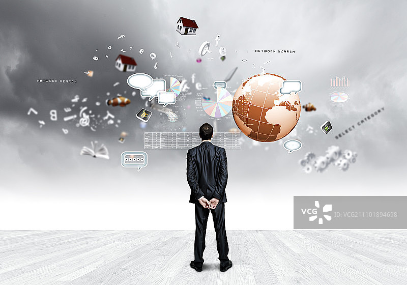 商业愿景：自信的商人看着空中飞舞的物品的背影图片素材