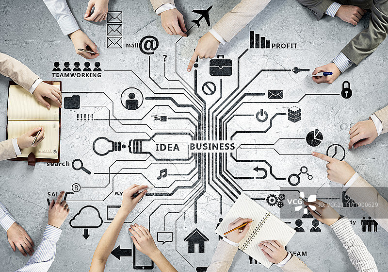 商务团队的创意工作。人们绘制商务团队合作战略的俯视图图片素材