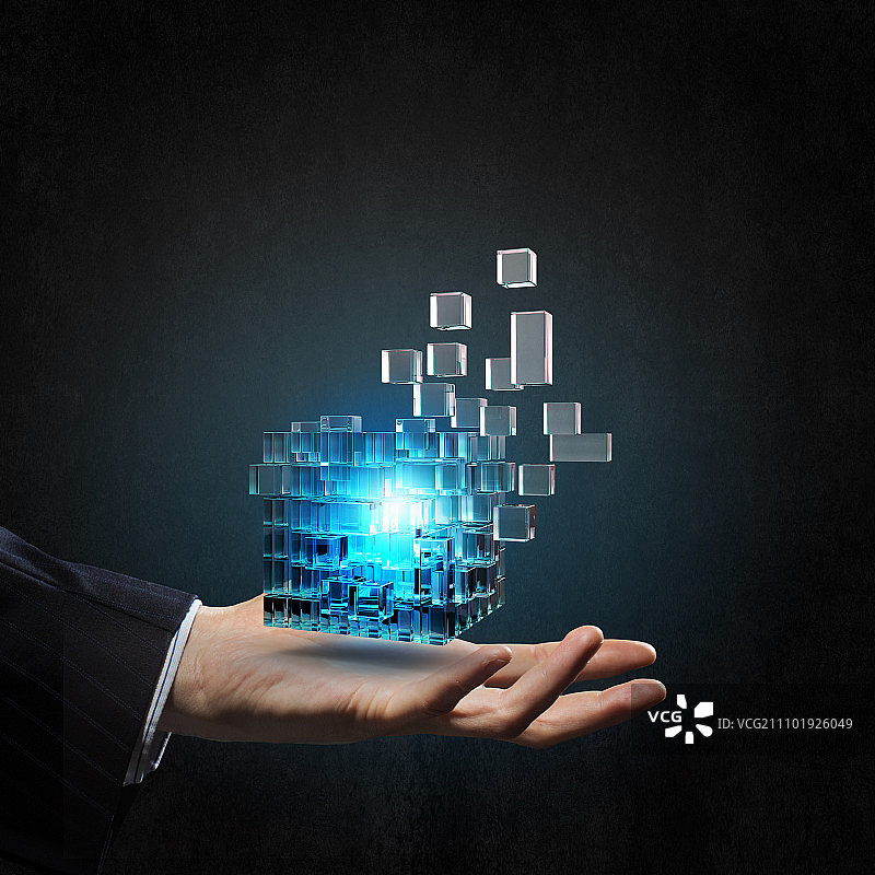 人力资源概念：商人手持发光魔方特写图片素材