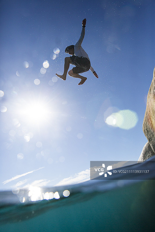 男子在沙港州立公园跳入河中岩石图片素材