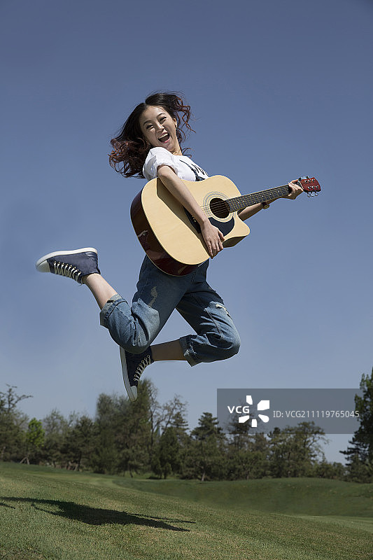 年轻女孩弹吉他图片素材