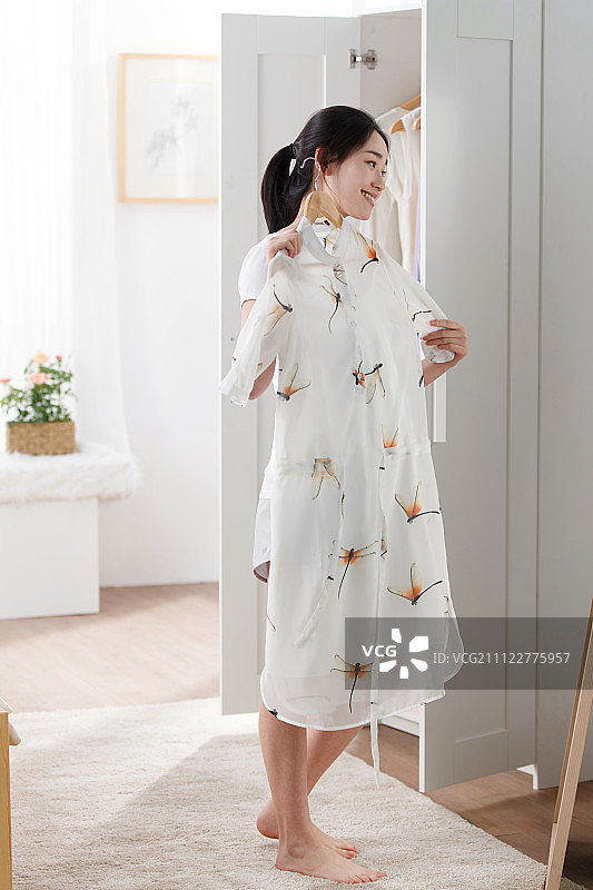 青年女人在卧室试衣服图片素材