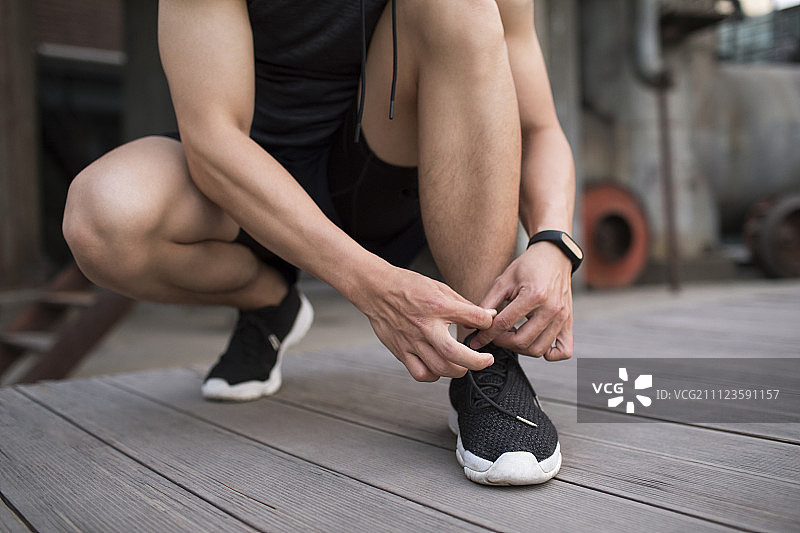 年轻男子系鞋带图片素材