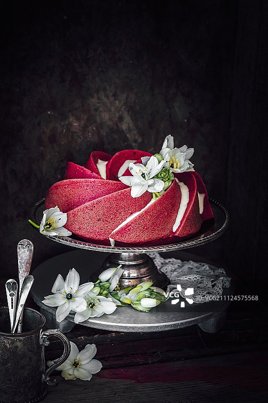 损毁的红色天鹅绒蛋糕，奶油和鲜花装饰图片素材