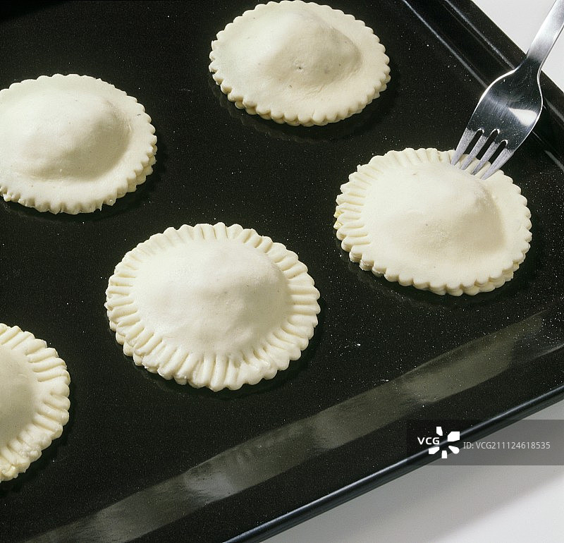 用叉子在托盘上切虾饼边缘的特写图片素材