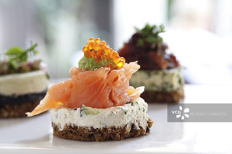 面包、奶油奶酪、三文鱼和鱼子酱制成的三文鱼寿司特写图片素材