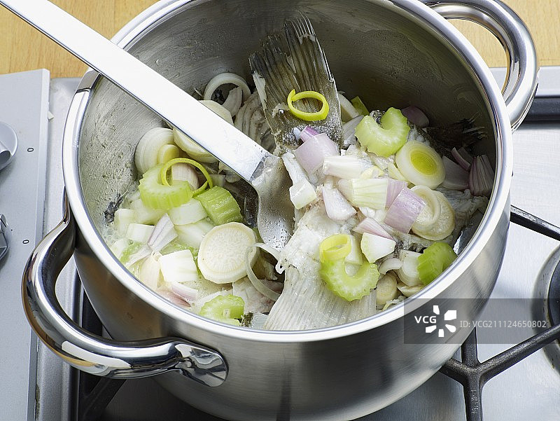 在锅中加入蔬菜和鱼，准备鱼汤，步骤3图片素材