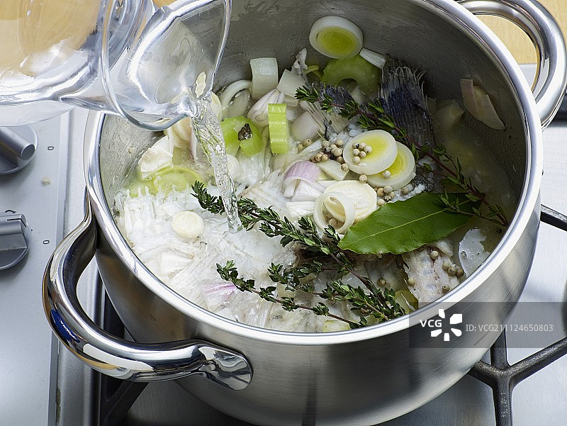 在平底锅中加入水和香料，准备鱼汤，步骤4图片素材