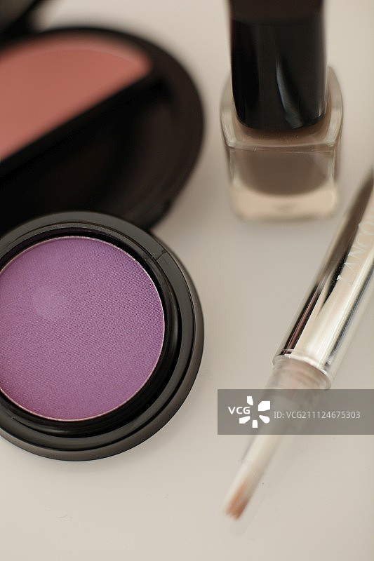 白色背景上的腮红、眼影、指甲油和遮瑕膏特写图片素材