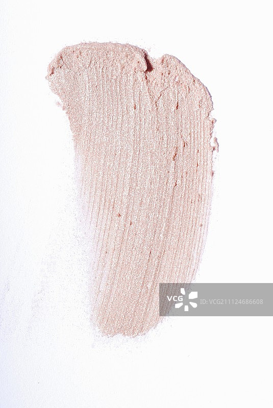 白色表面上的淡粉色唇膏图片素材