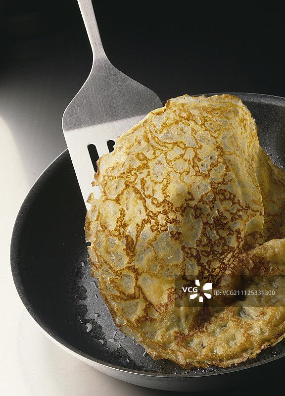 在煎锅中翻转可丽饼图片素材