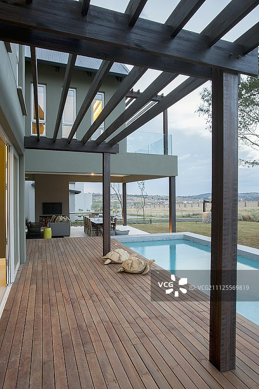带有凉棚、木制露台和游泳池的现代住宅图片素材