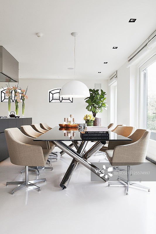 现代餐桌旁带浅色软垫的优雅转椅图片素材