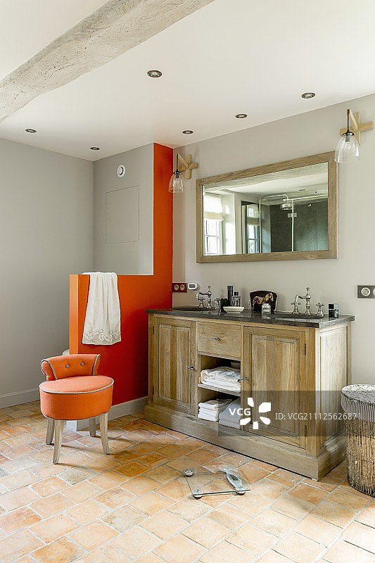 乡村风格的双人盥洗台，旁边是现代橙色砖砌马桶隔断和软垫凳图片素材