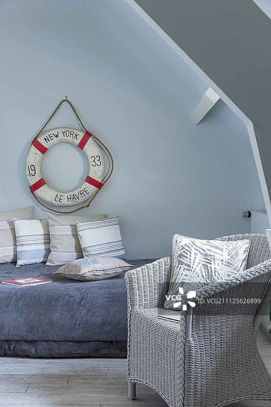 墙上的救生圈和白色柳条椅图片素材