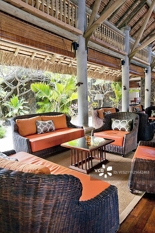 异域风情休息室内的橙色坐垫藤椅图片素材