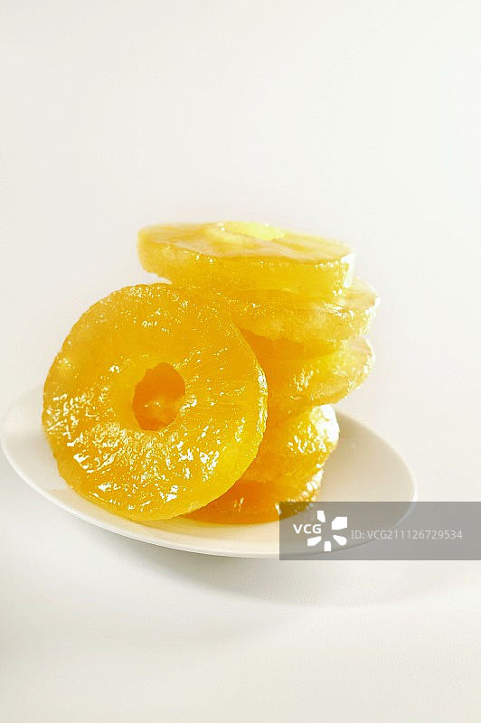 白色盘子，堆叠蜜饯菠萝圈图片素材