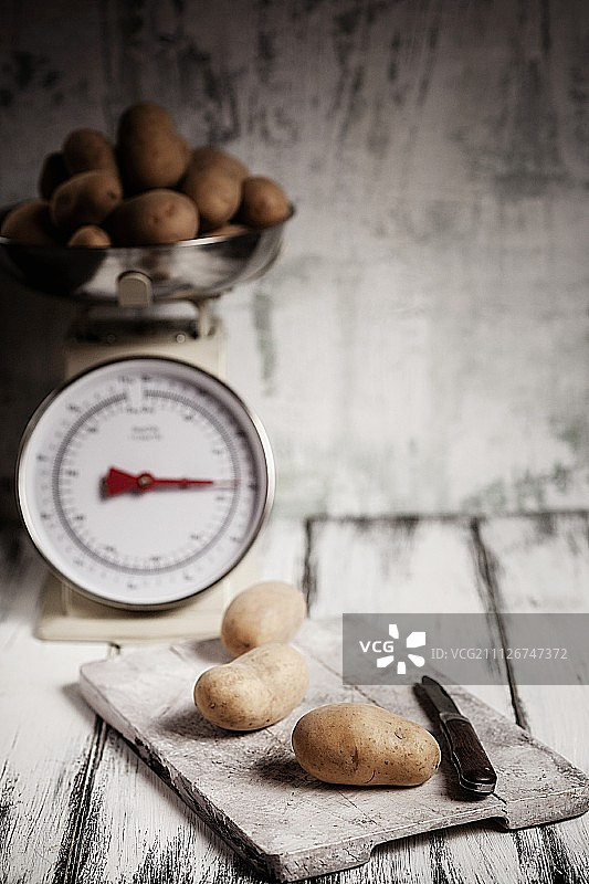 砧板和厨房秤上的土豆图片素材