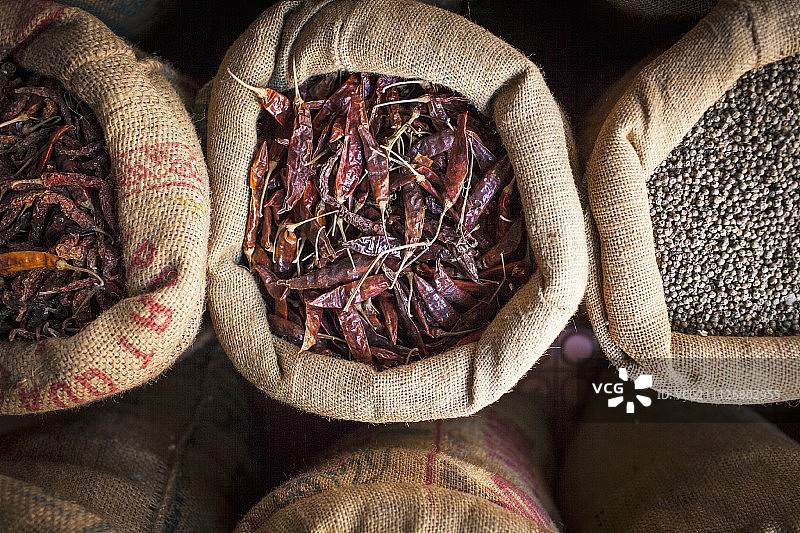 印度街头市场的黄麻袋中的干辣椒和鹰嘴豆图片素材