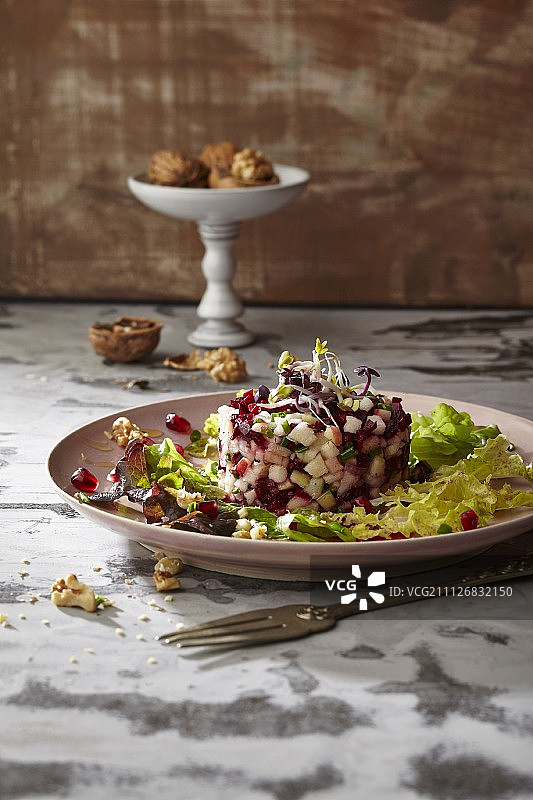 橡叶生菜配辣根芽、甜菜根苹果鞑靼和葡萄柚核桃腌料图片素材