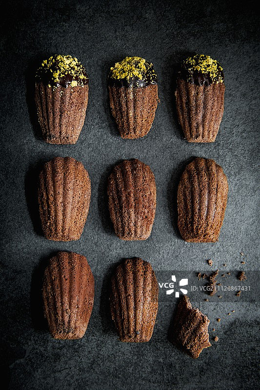 巧克力马德琳蛋糕，配巧克力釉和开心果碎屑（顶视图）图片素材