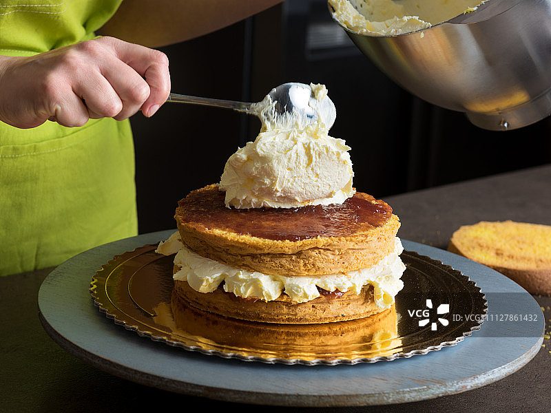 女人用糖霜装饰美味的蛋糕图片素材