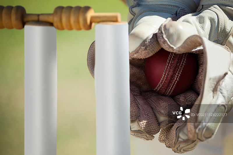 板球守门员在球门后接球的局部手部特写图片素材