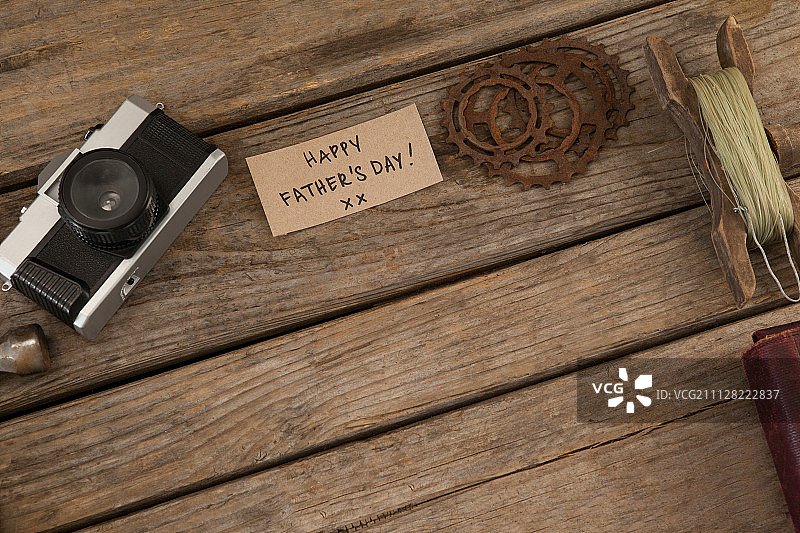 老式相机、卡片、钓鱼线和渔具在木板上的特写图片素材