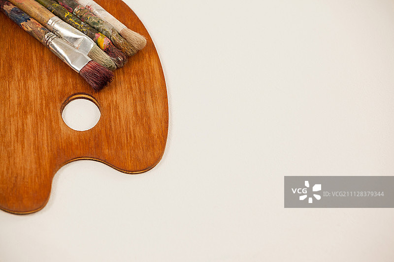 白色背景上的木制调色板和画笔图片素材