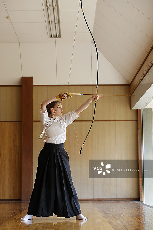 练习传统弓道的白人女性图片素材