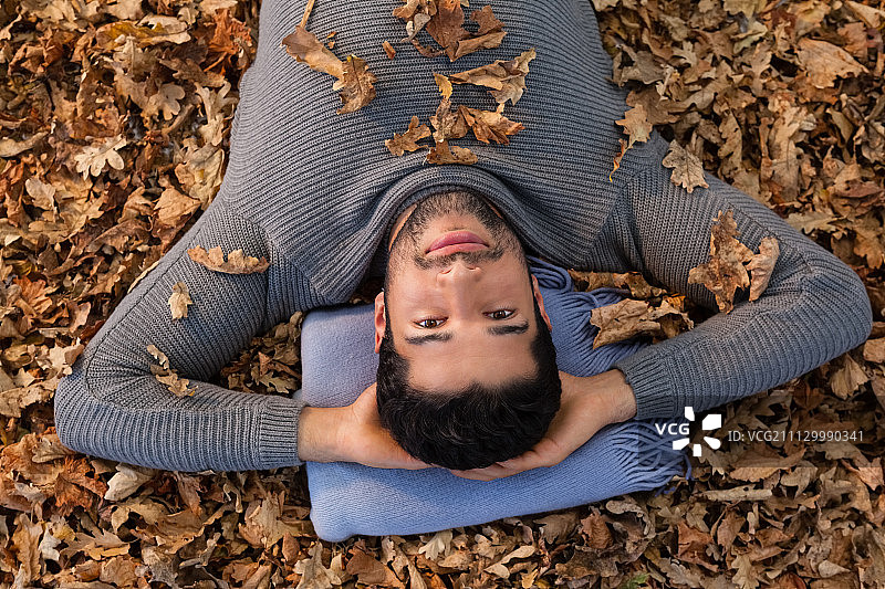 躺在秋叶上的男子肖像图片素材