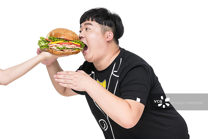扑向美食的肥胖青年男子图片素材