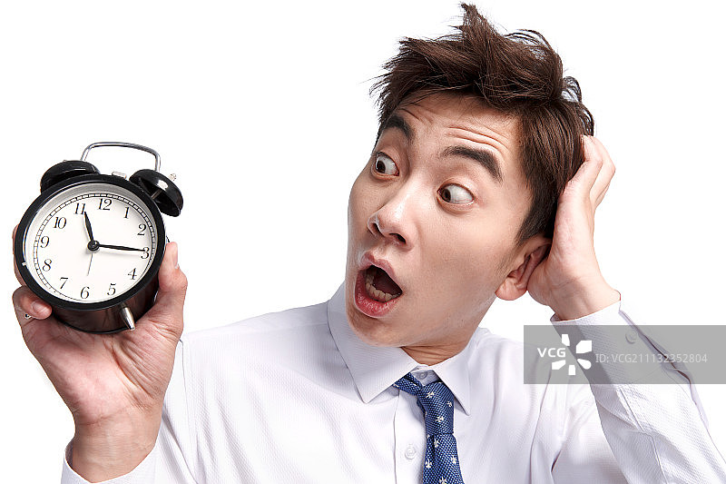 震惊的商务青年男人拿着闹钟图片素材