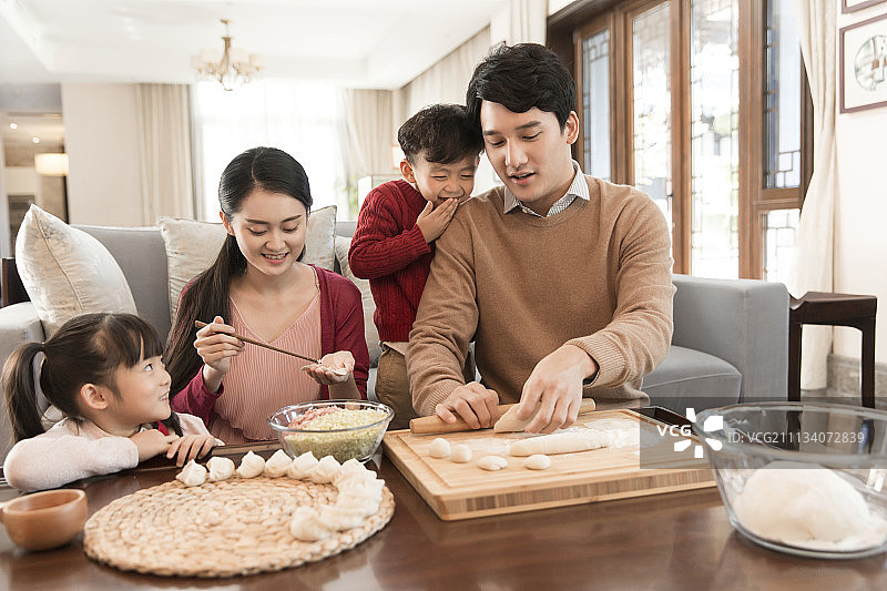 快乐一家四口新年包饺子图片素材