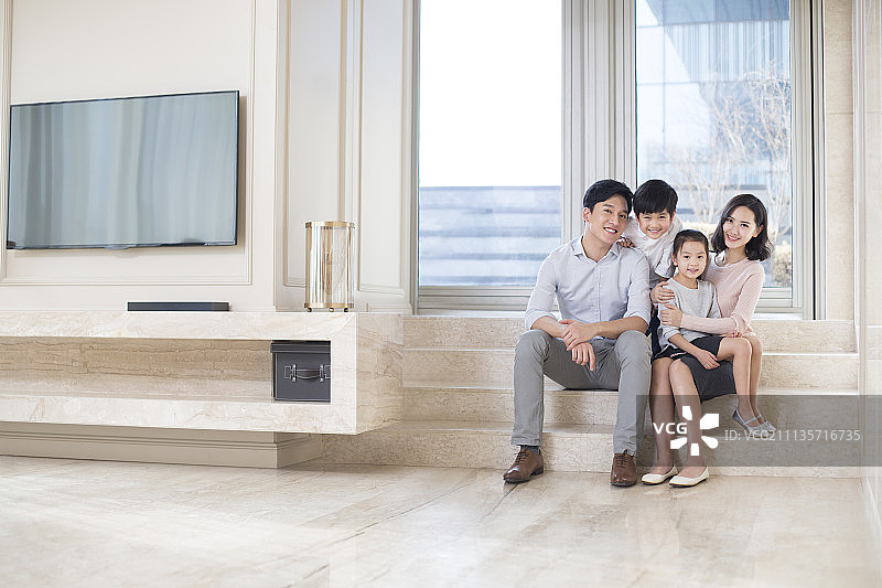 客厅里的快乐年轻家庭肖像图片素材