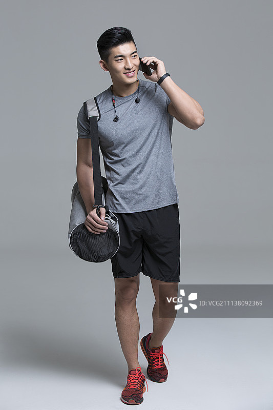 男运动员边走路边打电话图片素材