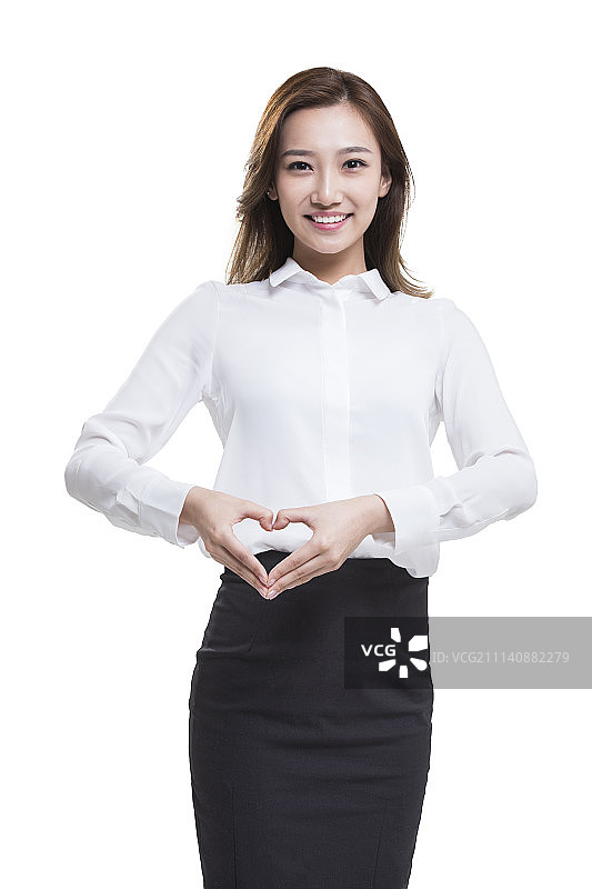 快乐的年轻商务女士摆心型手势图片素材