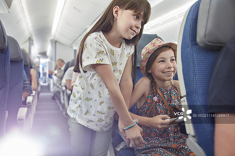 女孩在飞机上玩电子游戏图片素材