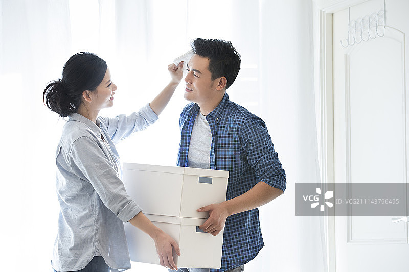 女朋友给搬家的男朋友擦汗图片素材