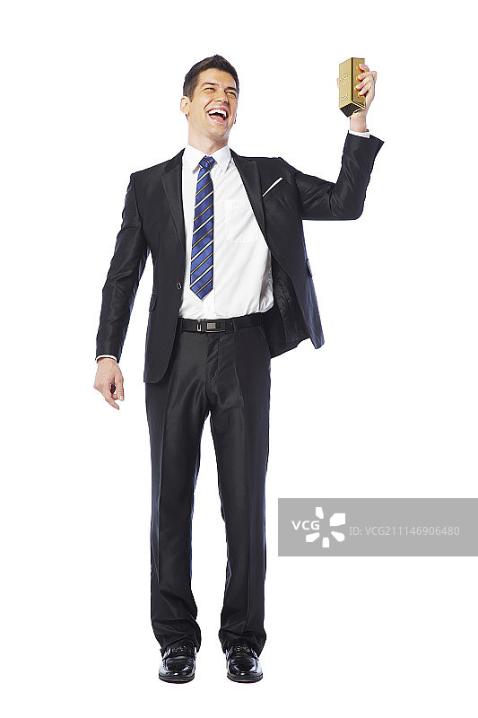 手持金条大笑的商人（影棚拍摄）图片素材