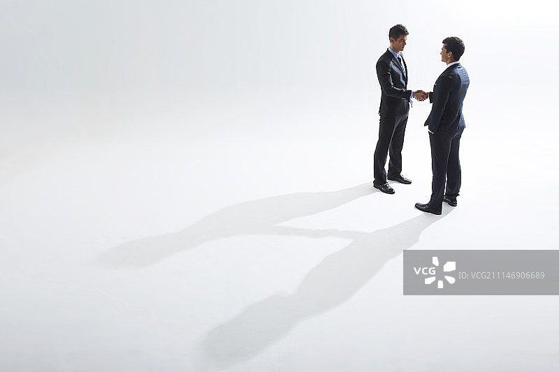 两位男士西装握手摄影棚拍摄图片素材